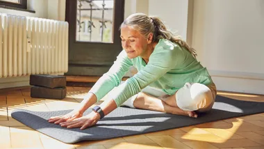 Woman stretching on yoga mat