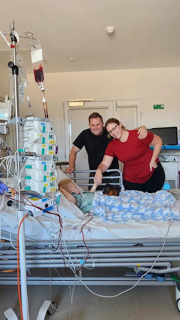 Parents Kylie and Dave Bacon with their son Tommy who was diagnosed with JMML.