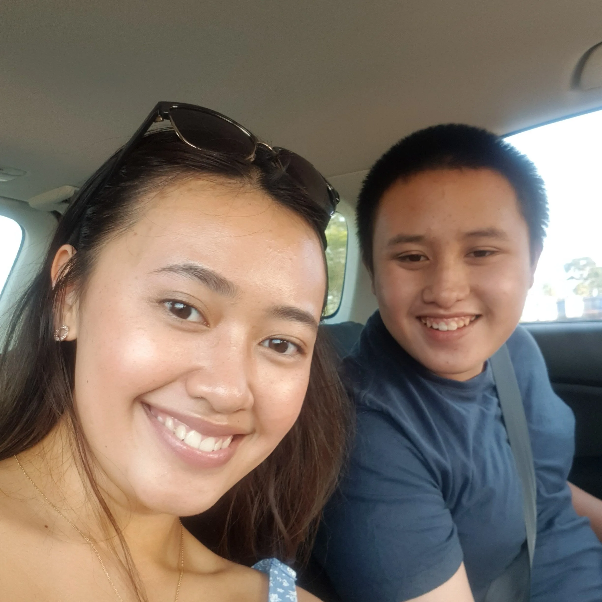A selfie of Levina and Tom sitting, smiling, in the car.