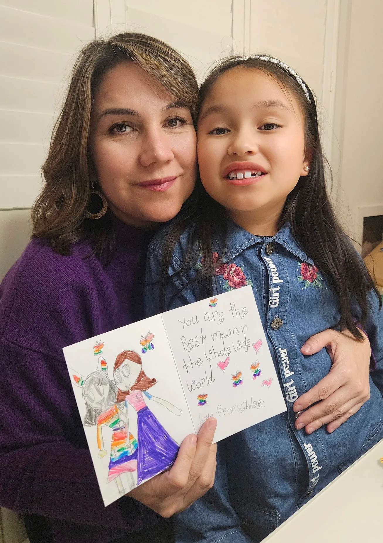 Tairyn holds Chloe on her lap and displays a card her daughter has written for her. In beautiful decorative writing it reads: 'You are the best mum in the whole wide world'. And Chloe has drawn a picture of Tairyn and Chloe with hearts and butterflies.
