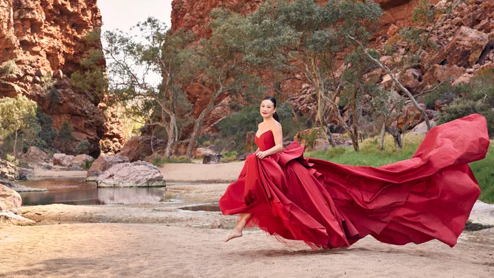 Poh Ling Yeow running in a red gown for a Christmas photoshoot.