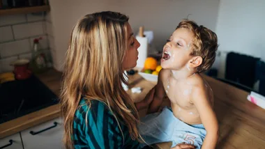 Mum checking child's throat who has measles