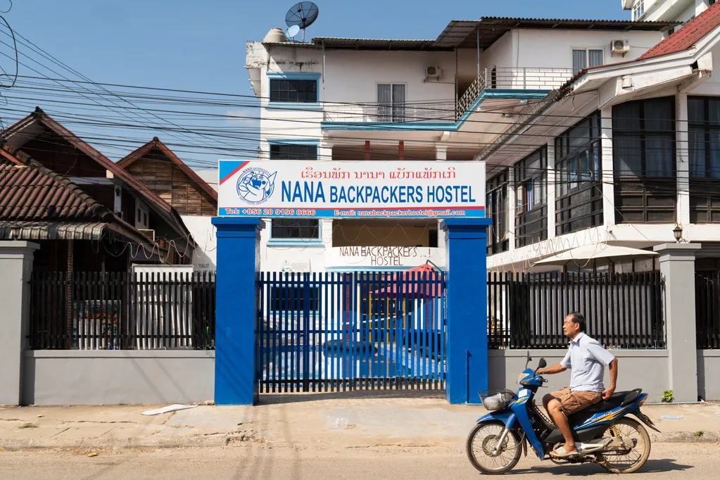 A motorcyclist passes the Nana Backpackers Hostel in Vang Vieng on November 24, 2024. The Laos government said on November 23 it was "profoundly saddened" by the deaths of foreign tourists in Vang Vieng, with the toll from a suspected methanol poisoning incident now at six. Six tourists died of suspected methanol poisoning after a night out in the Laos backpacker hotspot of Vang Vieng last week. (Photo by AFP) (Photo by STR/AFP via Getty Images)