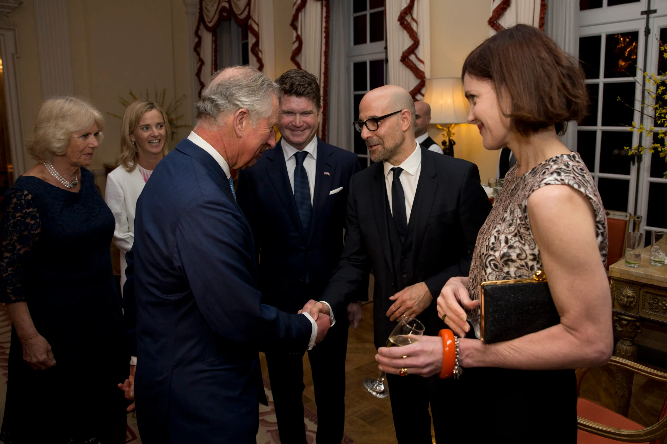 charles and stanley shaking hands at an event