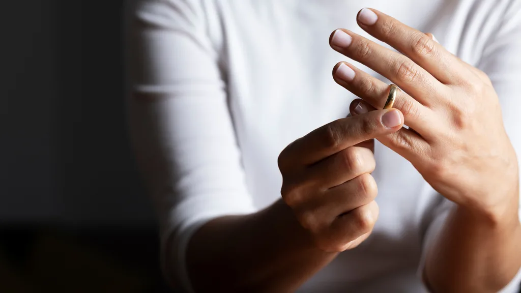 Is January really Divorce Month? A woman takes off her wedding ring