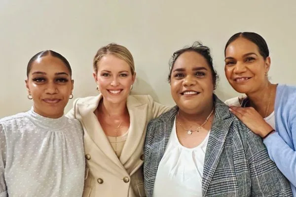 Four women smile at the camera - three wearing business-style jackets and the fourth and elegant grey dress. They are Donna Nelson's daughters and Jennifer Robinson.