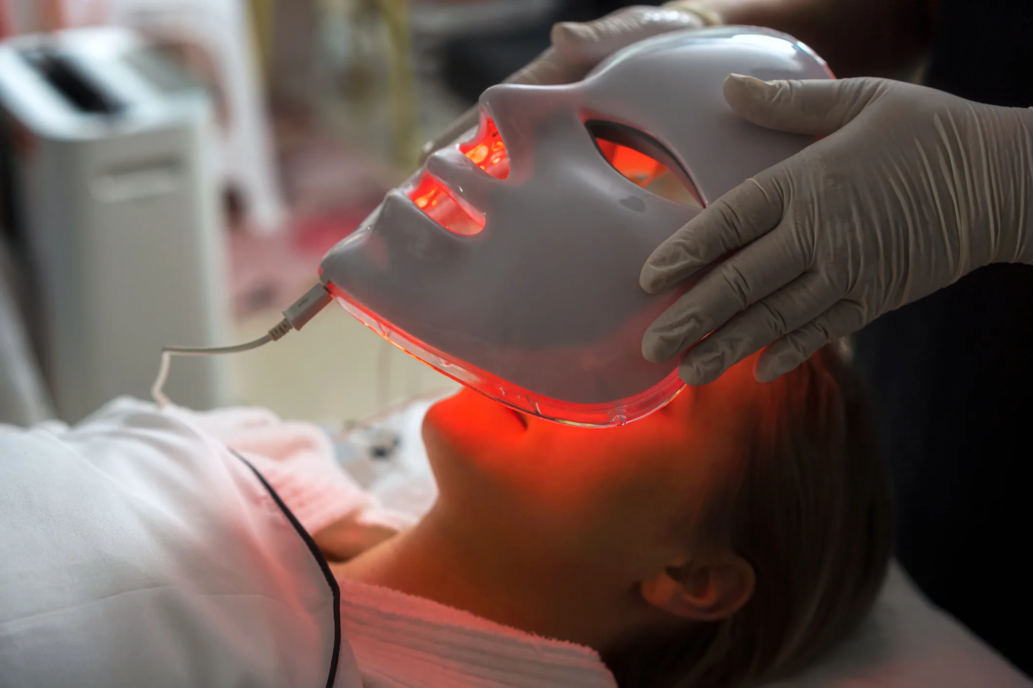 A woman getting an LED light treatment. 