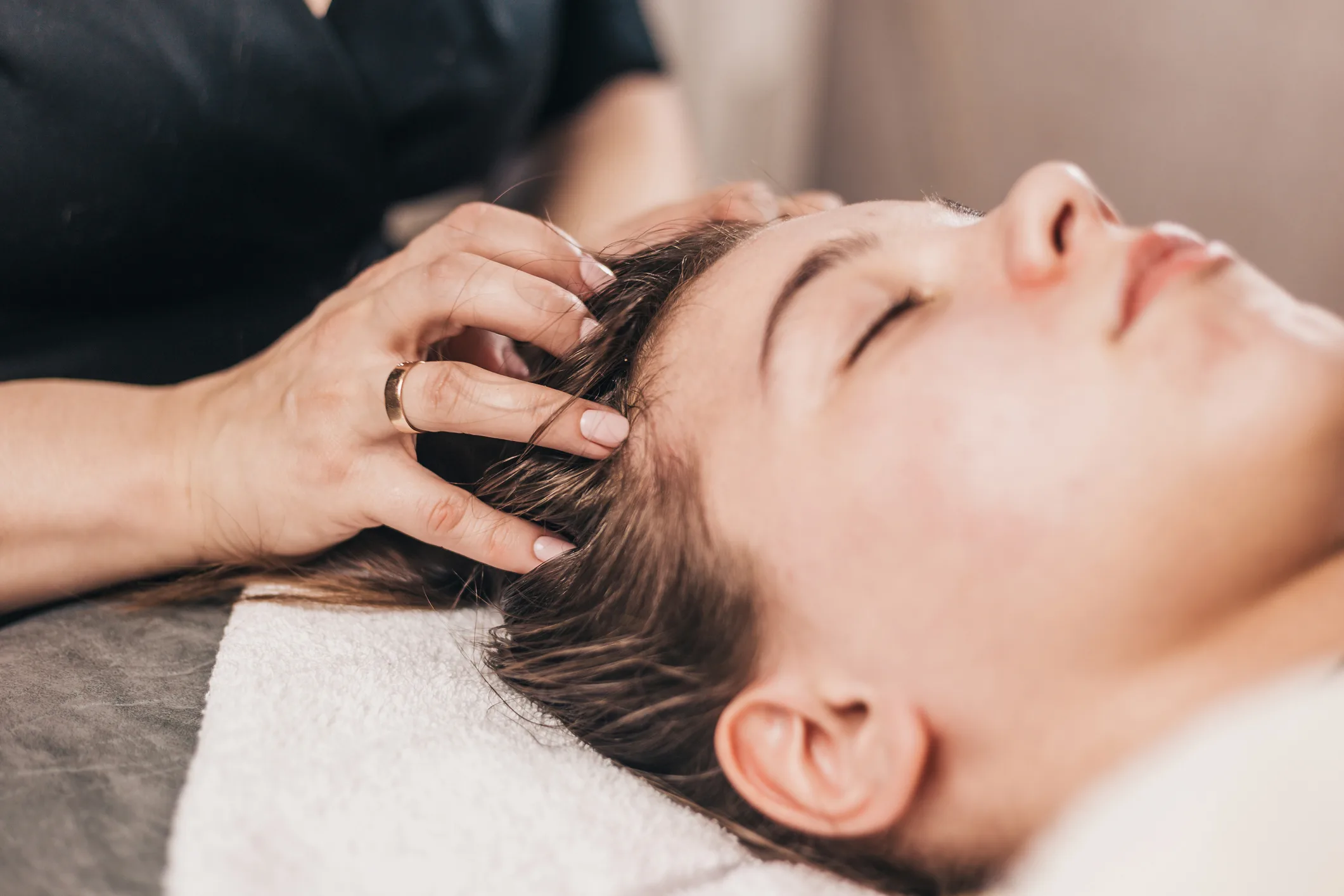 A woman receiving a head spa treatment. 