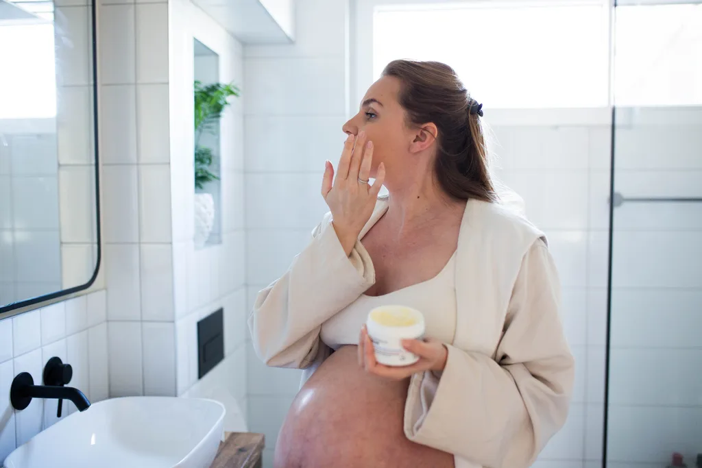Woman applying skincare safe pregnancy.