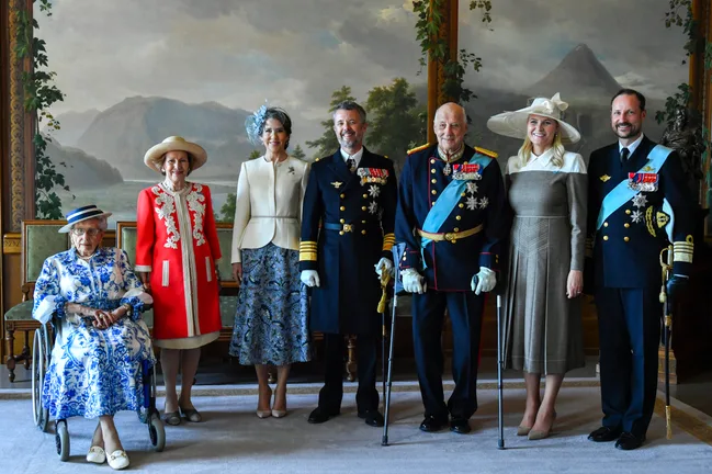 Queen Mary and King Frederik in formal attire.