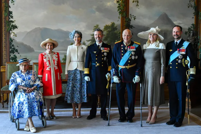 Queen Mary and King Frederik in formal attire.