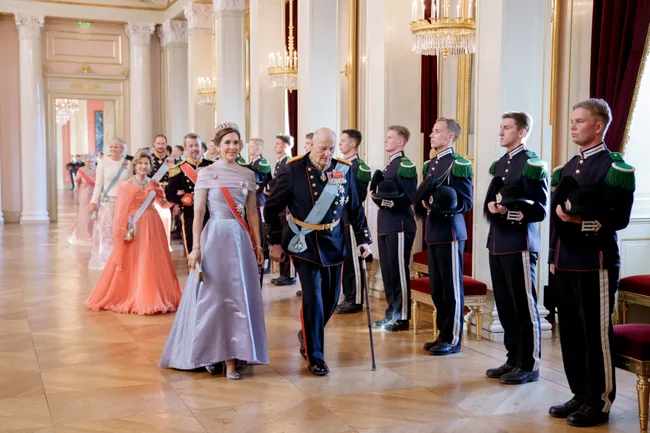 Queen Mary and King Frederik in formal attire.