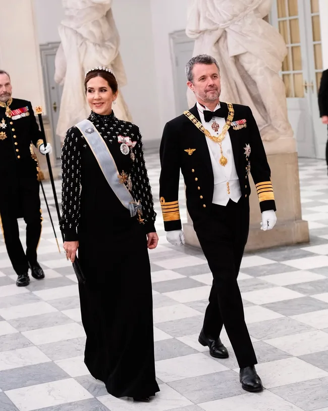 Queen Mary and King Frederik in formal attire.
