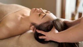 A woman receiving a scalp massage as a part of a Japanese head spa treatment.