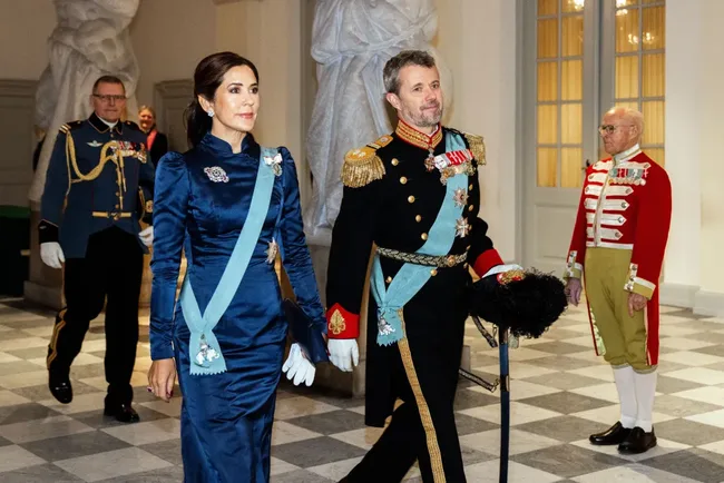 Queen Mary and King Frederik in formal attire.