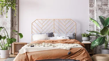 Wooden bed in loft apartment design, interior of bedroom with empty wall mockup