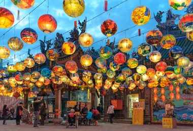 Pu Ji Temple Lunar New Year painted lanterns hand over a street in Taiwan.