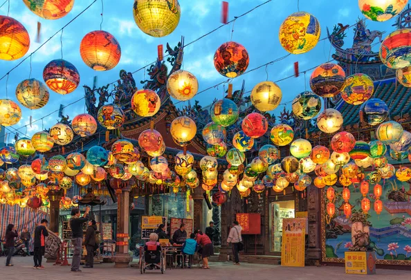 Pu Ji Temple Lunar New Year painted lanterns hand over a street in Taiwan.