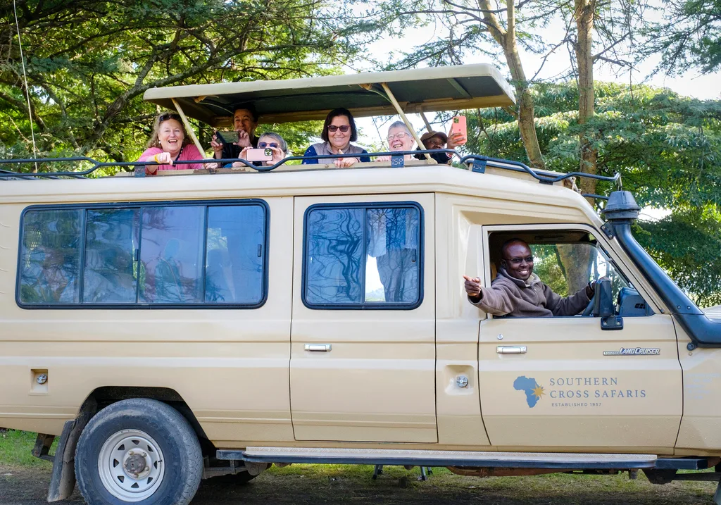 A group of women-only Kenya tour gusts in a safari van
