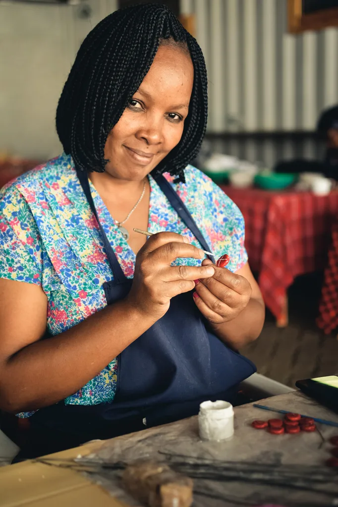 Female artist at the Kazuri Beads Factory in Kenya, a stop of the women-only Kenya tour.