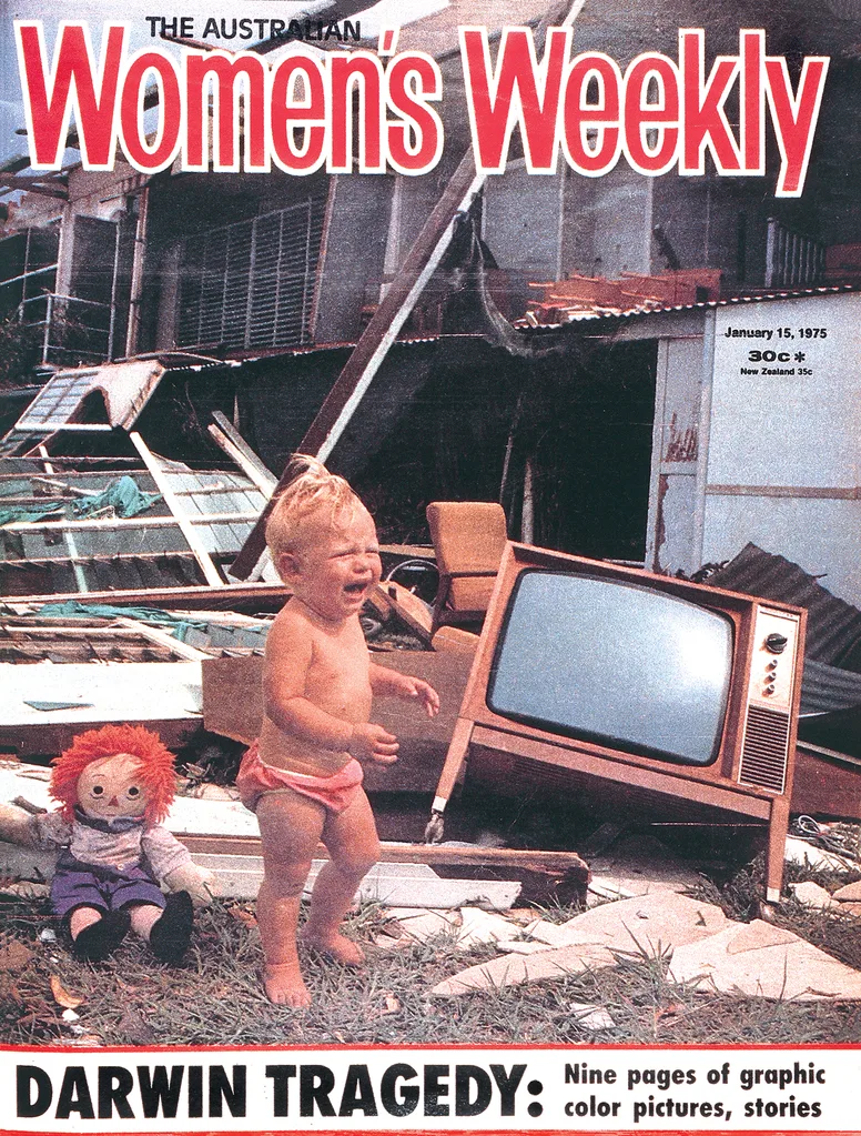 Cover of Women's Weekly magazine with a child crying beside a doll surrounded by cyclone wreckage.