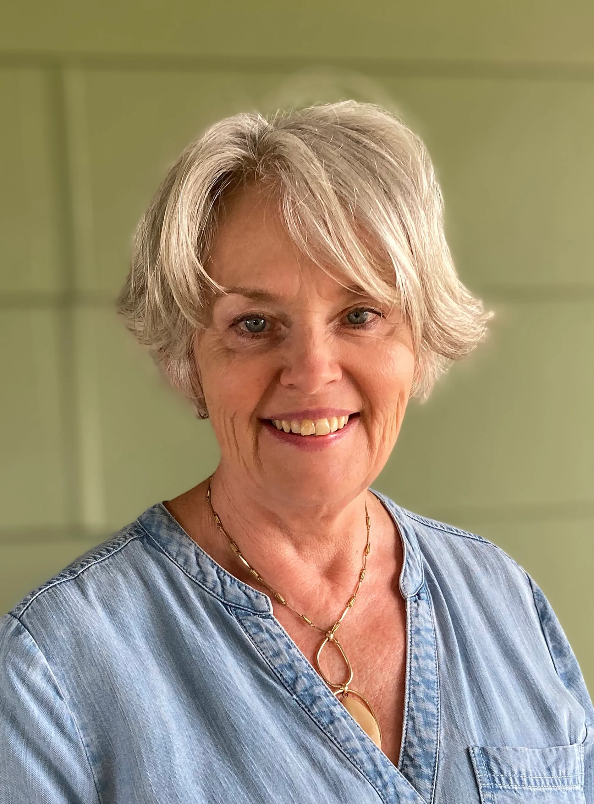 A blonde woman smiling.