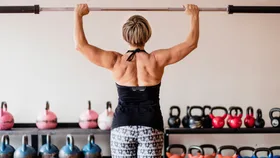 Mature woman at the gym lifting weights