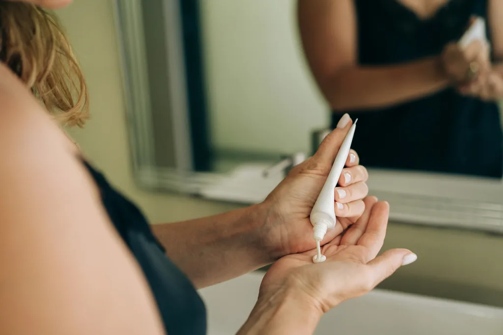 Woman applying sunscreen.
