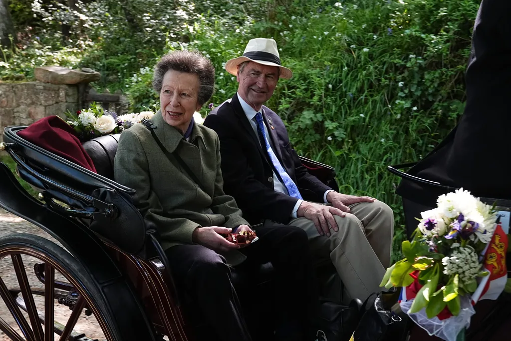 Princess Anne and her husband Vice Admiral Timothy Laurence in a horse drawn carriage in Guernsey