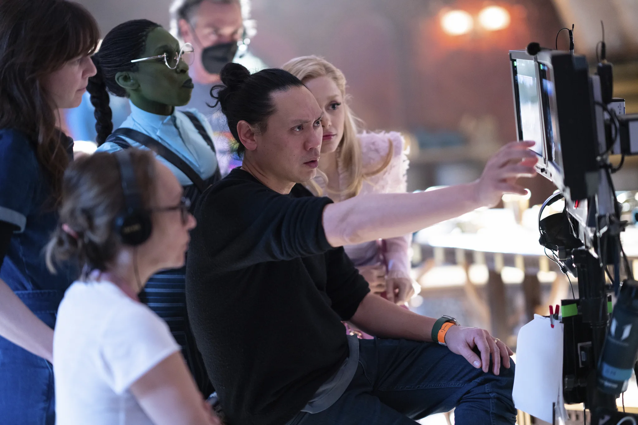 jon m chu, the director of wicked on set