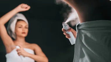 woman applying deodorant.