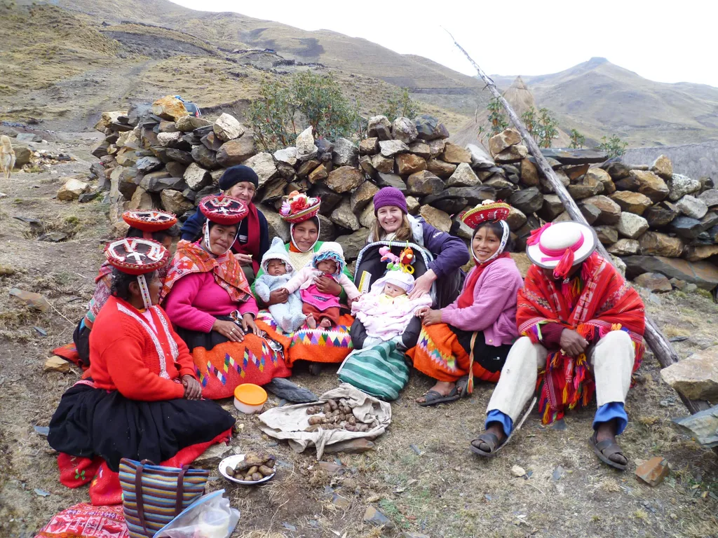 A group of women sitting together on a hillside.