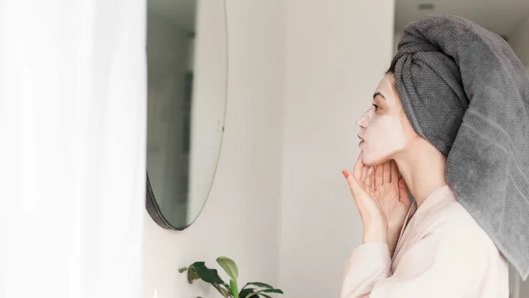 Woman doing DIY facial at home.