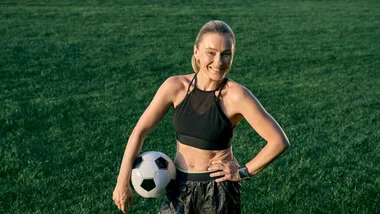mature age woman with soccer ball