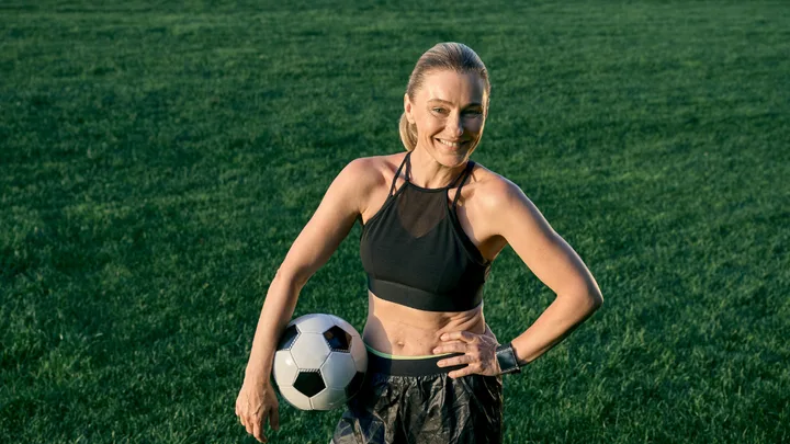 mature age woman with soccer ball