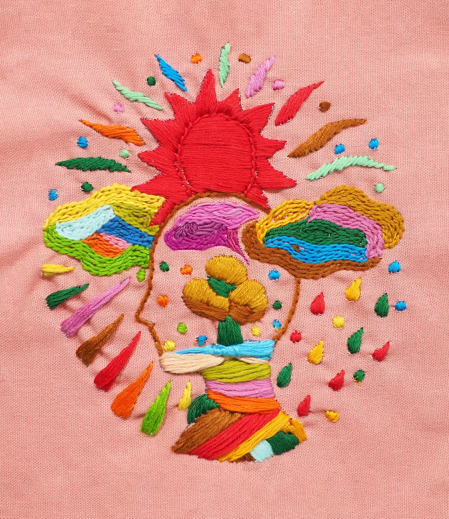 Image of an embroidery of a head with colourful shapes surrounding it