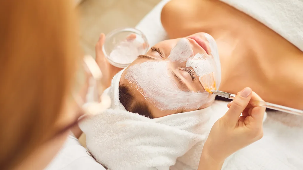 Woman splurging on a facial treatment.