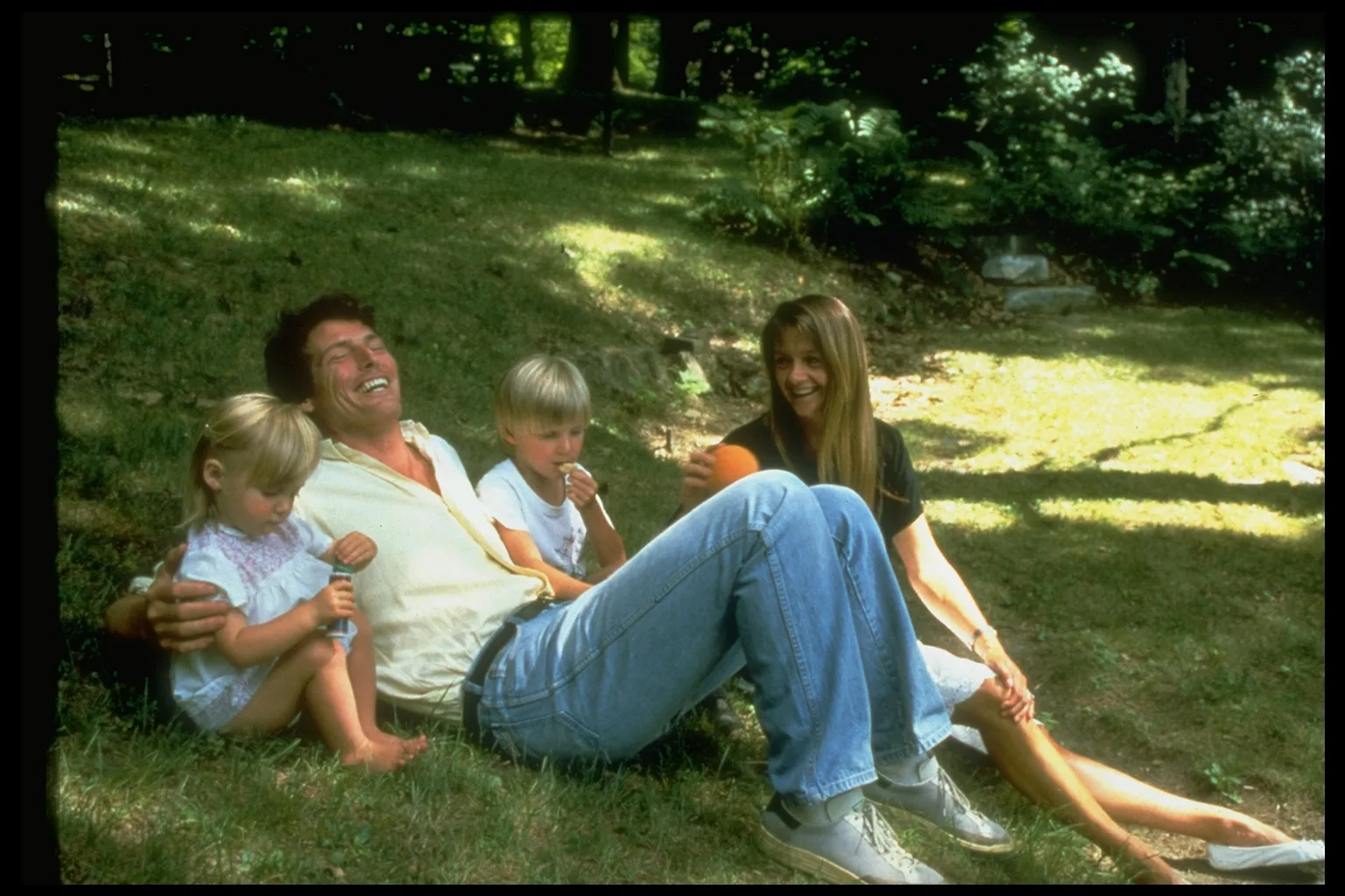Family lounging on a grassy slope: Alexandra Reeve; Christopher Reeve; Matthew Reeve; Gae Exton.