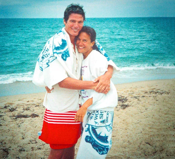 Christopher Reeve and second wife Dana Morosini hug on a beach
