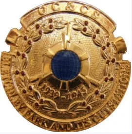A circular medal, golden coloured with a blue stone at the centre.