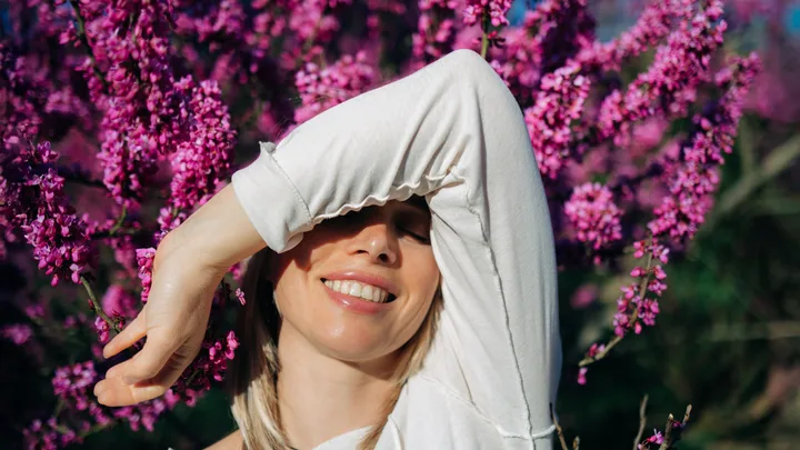Woman covering her face from the sun