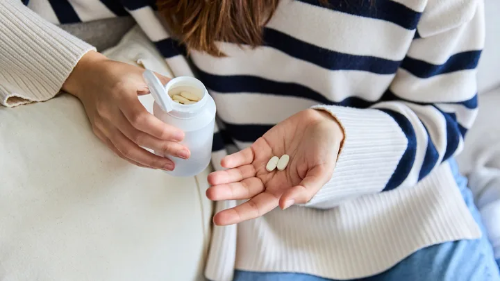 Woman taking vitamins pills