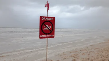 How to keep family safe in the water and prevent drowning. Image of a closed beach in Gold Coast