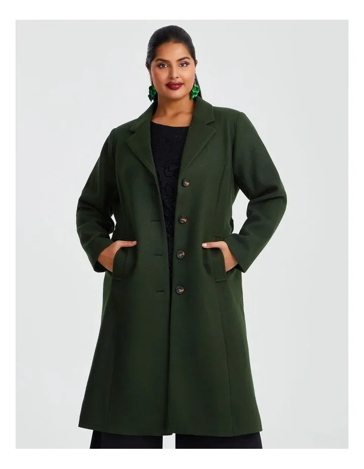 A woman wears a green winter coat