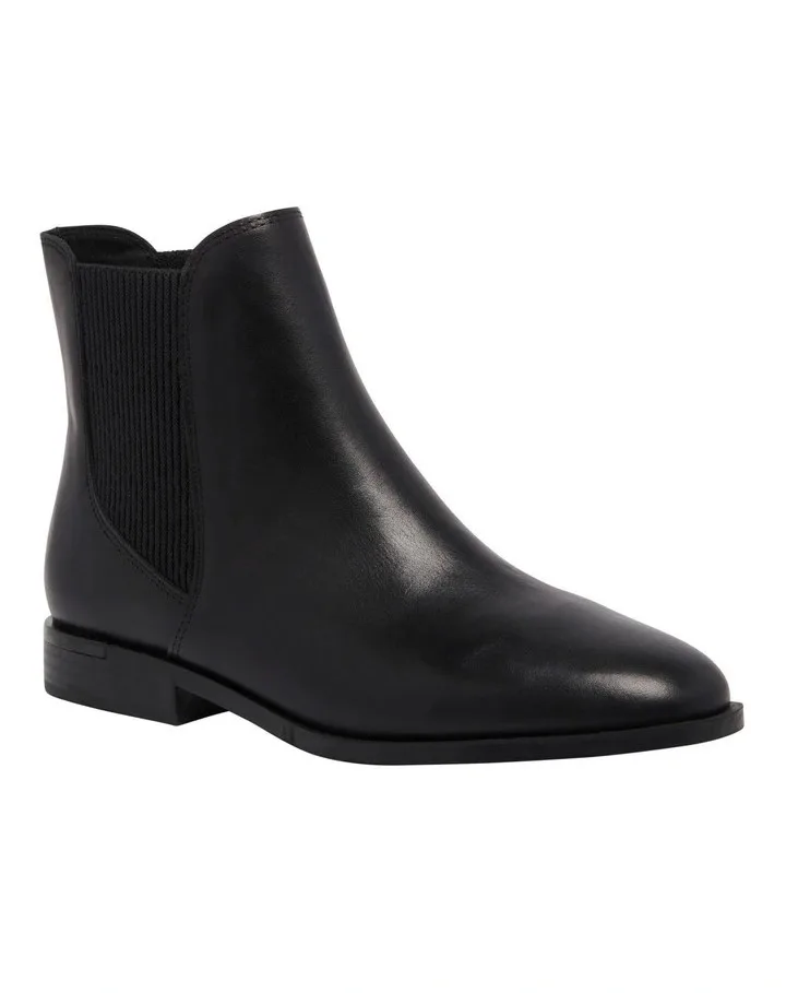 A flat black boot with pointed toe