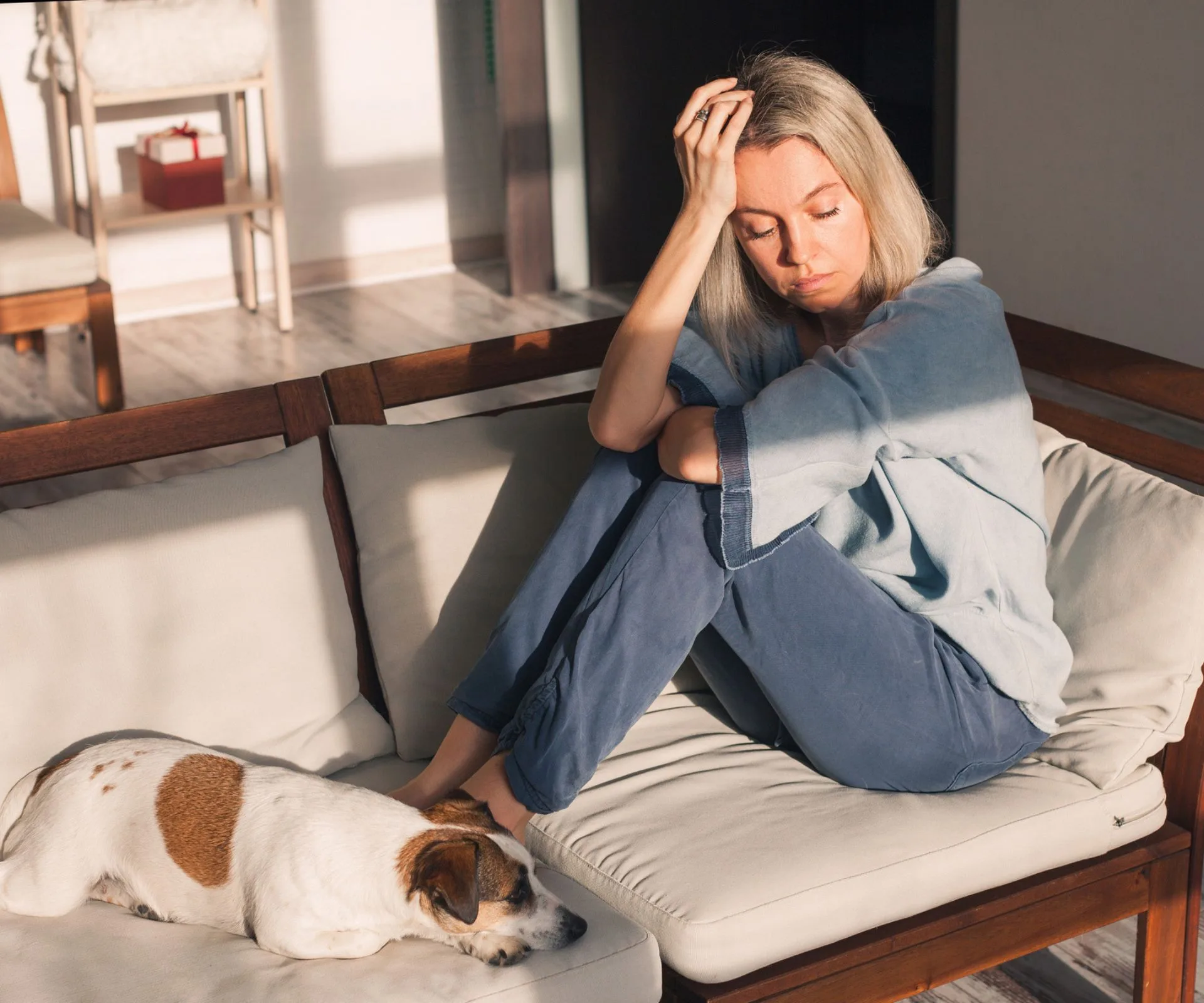 Women looking down on couch with dog