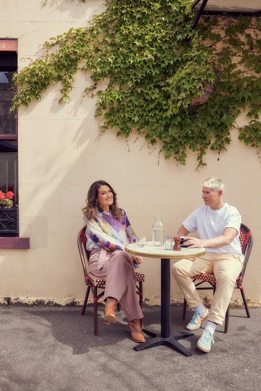 Patricia Karvelas and her wife Pet enjoying a coffee outdoors. Photo by Alana Landsberry.