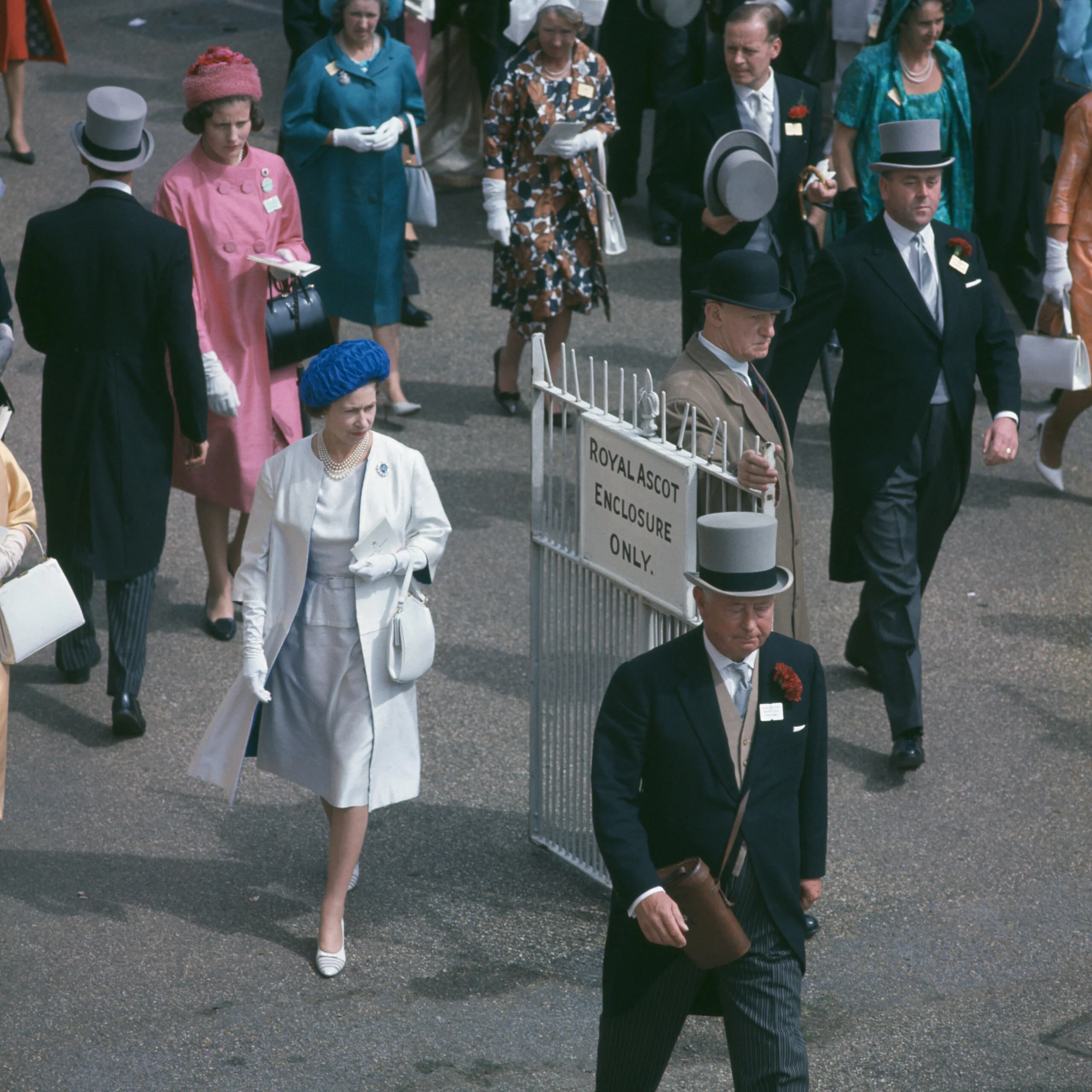 Queen Elizabeth II (in white, left) leaving the Royal enclosure at Ascot Racecourse, Berkshire, June 1963. (Photo by Fox Photos/Hulton Archive/Getty Images)