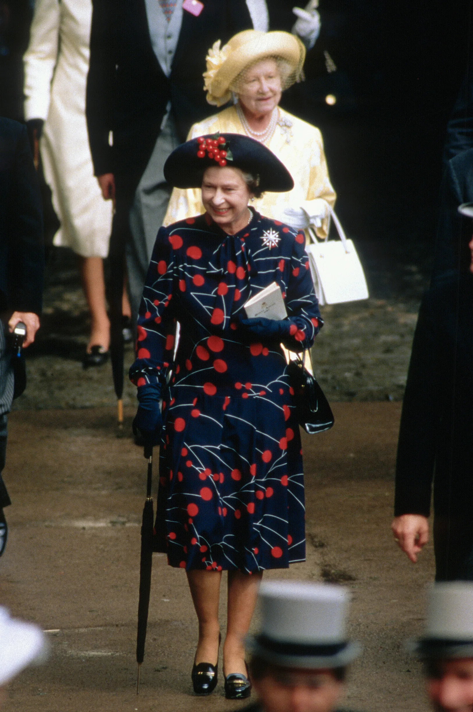 ASCOT, UNITED KINGDOM - JUNE 01: Queen Elizabeth ll wears red cherries on her hat and dress as she attends Royal Ascot on June 01, circa 190s in Ascot, England. (Photo by Anwar Hussein/Getty Images)