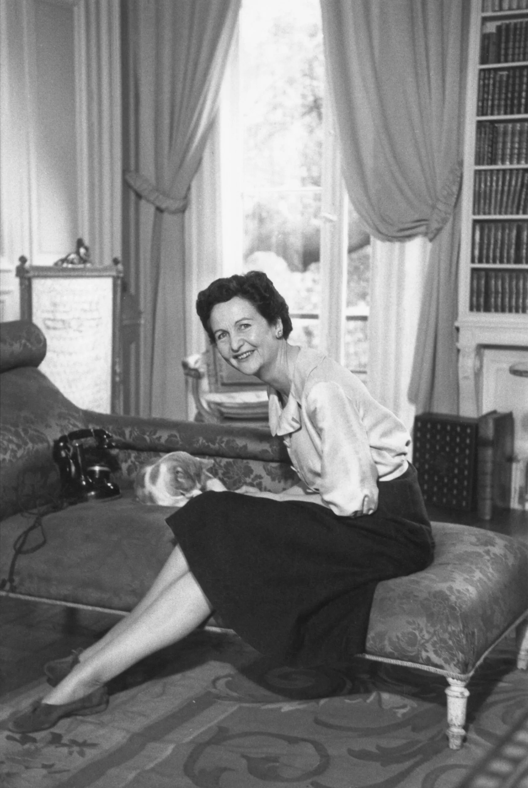 English writer Nancy Mitford (1904 - 1973) at her apartment in Paris, May 1956. Original publication: Picture Post - 8381 - Always True To U, Darling - pub. 12th May 1956 (Photo by Thurston Hopkins/Picture Post/Hulton Archive/Getty Images)